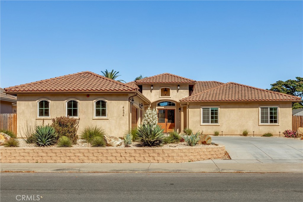 Welcome to 4654 Hummel Drive — a newer, single-story Mediterranean-inspired home in the heart of Orcutt, with no HOA fees. This turn-key custom build offers serious style, smart upgrades, and nearly 2,750 sq ft of functional elegance across 3 bedrooms and 2.5 bathrooms.
The current owner has invested $100K in upgrades to elevate the property inside and out. The professionally landscaped backyard includes pet-friendly turf, pavers, decorative rock, a cozy outdoor gas fireplace, and fruit trees (lemon, orange, Santa Barbara peach, and Fuyu persimmon). Timed path lights and uplighting enhance the ambiance, while a pushed-back rear wall adds both space and functionality. A storage shed offers added convenience and spacious lot to accommodate RV parking. Interior perks include roller shades, privacy film on the bathroom window, polyurea-coated garage flooring, upgraded lighting, custom cabinetry, and a keyless entry system.
Inside, enjoy soaring ceilings, abundant natural light, and a grand entry leading into an open-concept layout — ideal for entertaining or relaxing. The kitchen features white quartz counters, premium stainless appliances, and flows seamlessly into the great room and backyard.
Owned solar, a tankless water heater, and a modern fire suppression system add efficiency and peace of mind. All just minutes from parks, trails, shopping, restaurants, and the charm of Old Town Orcutt.