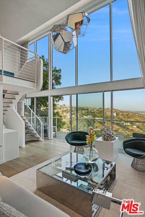 EXTRAORDINARY CITY VIEWS from Modern 3+3 furnished residence, created by acclaimed interior designer James Anthony Magni and award-winning architect Marcello Pozzi, AIA. Dramatic, two-story walls of glass maximize stunning vistas from nearly every room. Entry level incorporates spacious dining area, chef's kitchen, bedroom, bath, garden courtyard, and garage. Lower level highlights 2-story great room, sitting room alcove, guest room, bath, plus sumptuous primary ensuite including spa-like bath. Generous rear deck spans width of home providing sitting areas and sumptuous infinity pool overlooking the city. Located minutes off of Laurel Canyon Blvd., property is exceedingly private yet minutes from Hollywood, Beverly Hills, the Valley, and all that LA offers including choice restaurants, shopping, and nightlife. Located within the Wonderland Park School District.