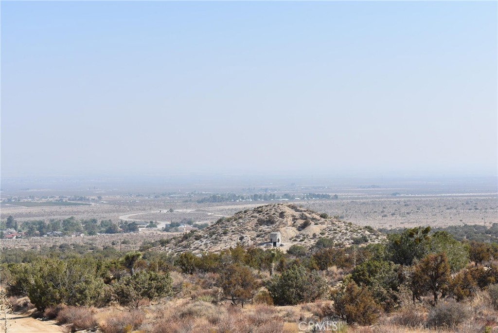 1.25 acre lot in the hills above Crystalaire. Views all around. 165 feet of frontage on 161st St and 330 feet deep. Residential lot zoned for horses and agriculture. Adjacent 1.25 acre lot is also for sale. Several homes in the area, and one directly west of this lot. Power and water run down the street across the lot. Water provided by the Llano Mutual Water Company. APN 3061-021-016.