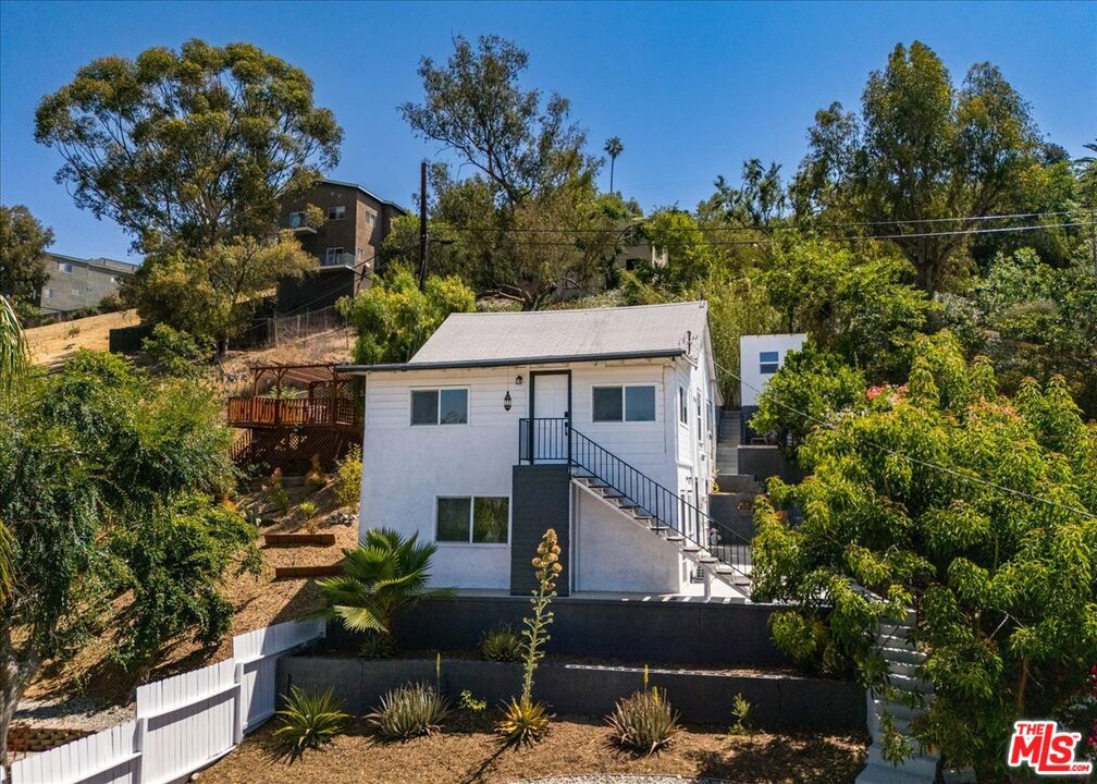 This hilltop Duplex has breathtaking views of the city skyline, hills, and mountains, offering a picturesque backdrop for your new home. This two-story residence features a unique split-level design with two separate units, providing versatile living options. The top unit includes 2 bedrooms and 1 bath, while the lower level offers 1 bedroom and 1 bath. Each unit is bright and spacious, showcasing an open floor plan with modern upgrades throughout. Step inside to discover freshly painted interiors, new flooring and lighting, and dual pane windows that enhance the home's aesthetic and energy efficiency. Both units come equipped with mini split HVAC units, modern appliances, and their own laundry room areas. There is a bonus separate studio/office space providing multiple options. The property sits on a generous 6,515 square foot lot, offering ample space for outdoor enjoyment. Step outside to discover a private patio and deck area, offering stunning panoramic views of the city skyline, surrounding hills, and mountains. The perfect setting for entertaining or simply unwinding. The detached 2-car garage provides off street parking. Also included are preliminary plans for an ADU above the garage area, should you desire to improve the property and add more value. Don't miss the chance to own this incredible property, just minutes from Mt. Washington, Highland Park, Downtown LA, Dodger Stadium, and the vibrant amenities of city life. This is a must-see opportunity to experience the best of Los Angeles living.