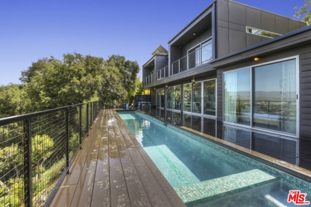 Available immediately as a short-term lease. This chic, private street and gated sanctuary in a perched cul de sac is hidden from, yet close to the life and style of Venture Blvd, the studios and a bridge away from the hubbub of Hollywood. Clean lines define this solar powered home complete with Tesla/electric car solar charging station completing the easy convenience of modern luxury. Sophisticated open Gaggenau kitchen interior, bedrooms, office and master suite retain a welcoming warmth with radiant floor heating. Fleetwood doors reveal the lush greenery leading to the outdoor life with pool and spa the complete this example of the best of Los Angeles life.
