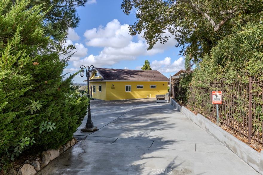 Built brand new and never lived in, this detached ADU at 7655 E Silver Dollar in Anaheim Hills offers exceptional privacy, mountain-style surroundings, and beautiful hillside views from the main living area. Located on a quiet cul-de-sac, the home features approximately 960 square feet of single-level living plus more than 900 square feet of finished attic space for flexible use. Designed with its own private driveway and entry, the property combines open concept living, high-end finishes, and expansive outdoor space with parking for multiple vehicles. ALL UTILITIES INCLUDED simplify monthly living while providing added value and convenience.



The main level opens to a bright great room with double sliding glass doors framing hillside and tree-lined views. The kitchen, dining, and living areas connect seamlessly for easy flow, featuring quartz countertops, custom cabinetry, stainless steel appliances, and generous workspace. Each room includes a dedicated ductless air conditioning unit for personalized comfort. The primary bedroom also enjoys sweeping views through a sliding glass door, a large walk-in closet, and direct access to a beautifully finished full bath with dual sinks, quartz counters, and blue-toned stone surfaces resembling marble.



A laundry room sits adjacent to the bath with built-in cabinetry and quartz countertop workspace. Upstairs, a staircase leads to a full-length finished attic offering over 900 square feet of flexible use ideal for an office, studio, or media room. The property is surrounded by open grounds with a wide variety of mature fruit trees, including pomegranate, persimmon, orange, lemon, tangerine, avocado, peach, guava, and apple. Tenants are welcome to enjoy the fruit grown on site, adding a special touch of California living to this private setting.



Parking is plentiful, with space for numerous vehicles inside the private area. The cul-de-sac location enhances privacy and quiet surroundings while remaining close to Anaheim Hills amenities, shopping, and freeway connections.