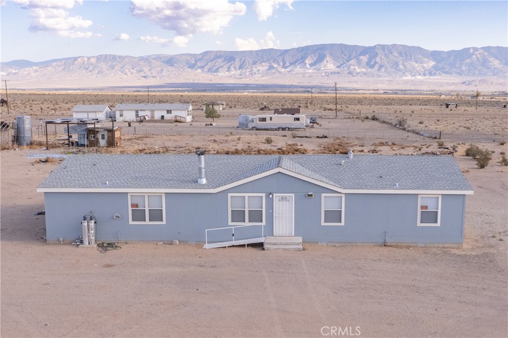 PRICE IMPROVEMENT! This spacious 5-bedroom, 3-bathroom mobile home sits on 2.5 private acres and offers the perfect blend of comfort, function, and opportunity. Recently updated with granite countertops, new carpeting, and hardwood flooring throughout, the home features a split floor plan designed for privacy and plenty of room for the whole family. A private well, drilled within the last five years by a reputable local contractor, provides a reliable water source, complemented by a full-home filtration system for clean, fresh water. An owned propane tank gives you the freedom to choose your supplier, while the home’s permanent foundation—with 433A recorded—adds peace of mind for financing. Tucked away on the back corner of the property is a second 2-bedroom, 1-bath mobile home with water and electricity already connected. With a little attention, it could be transformed into a charming rental or guest house, creating excellent income potential. There’s ample space to expand, customize, or simply enjoy the open land. The seller is motivated and has priced the property to sell quickly—this is a rare opportunity to secure a spacious home with built-in versatility and room to grow.