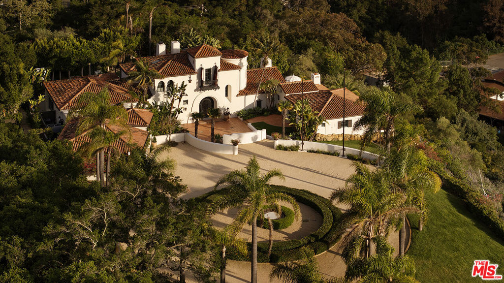 Experience the pinnacle of Santa Barbara living at Villa Ladera, a stunning hilltop estate, designed by famed Spanish Colonial architect Henry Lenny, nestled within the exclusive Hope Ranch community. Comprising two separate legal private gated parcels spanning 7.59 acres this meticulously renovated Spanish Colonial Revival-style home combines timeless elegance with modern luxury and elevated style. With sweeping panoramic views of the mountains, ocean, and La Cumbre Country Club fairways, the property offers an idyllic retreat that defines resort-style living.Recently renovated and designed by notable New York-based designer Noa Santos, the spacious residence encompasses over 6,000 square feet and features 4 bedrooms - each with a private bath, in-law suite, library, and a 3-car garage. The romantic primary suite boasts ocean and mountain views from the balcony, a fireplace, his and hers closets, a steam shower and radiant floor heat for ultimate luxury and relaxation. Designed for both casual entertaining and fine dining, the expansive kitchen boasts custom finishes like Calcutta marble, handmade Tunisian tiles, and premium dual La Cornue ranges. The home's chic designer lighting fixtures by Rose Uniacke and In Common With and carefully crafted details enhance its unique character, offering a sense of timeless sophistication. Throughout the home you will find extensive custom millwork providing ample and beautiful storage spaces. Outside, the property is a true sanctuary, with multiple outdoor entertaining spaces that include a heated pool, jacuzzi, multiple fountains and a romantic outdoor fireplace all surrounded by beautiful mature landscaping. The meticulously landscaped grounds are perfect for gatherings, offering numerous intimate dining areas,, a custom chicken coop, with over 150 Avocado, Citrus, and Pomegranate Trees and a children's playground, all designed to take full advantage of the breathtaking vistas. The property also boasts a private well and a state-of-the-art whole house reverse osmosis water filtration and softening system. The additional 2+ acre parcel of land (3907 Via Laguna) offers additional privacy and space or the option to build a second 10,000 sq.ft. master estate home, with its own ADU. In addition to the luxurious amenities of the home, the property includes key card access to the enviable private Hope Ranch beach, 22 miles of equestrian trails, direct access to a Class 1 bike path, tennis courts, and private security force ensuring an unparalleled lifestyle of peace and convenience. Located just minutes from downtown Santa Barbara and Montecito, this estate combines privacy with proximity to the best the city has to offer. Villa Ladera is the perfect blend of sophistication, comfort, and tranquility.
