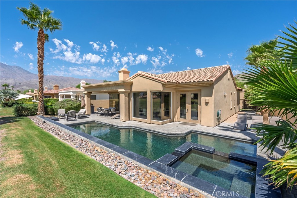 Experience resort-style living with panoramic, unobstructed views of both the 17th and 18th fairways of the prestigious Tom Weiskopf Private Course. This highly sought-after Ryder II floor plan is perfectly positioned to take full advantage of the breathtaking setting.
Enjoy desert living at its finest on the expansive patio, complete with a custom in-ground spa — perfect for relaxing or entertaining. Inside, the owner has thoughtfully updated features throughout, and the light-filled great room showcases nearly floor-to-ceiling windows, a cozy fireplace, wet bar, and an open-concept kitchen and dining area designed for both comfort and functionality.
The main residence offers two spacious bedrooms, including a primary suite with a large walk-in closet. A detached casita serves as a private third bedroom or an ideal home office, offering flexibility for guests or work-from-home needs.
Additional highlights include a two-car garage plus a dedicated golf cart garage. This home blends modern updates with an unbeatable location — a true PGA WEST gem!