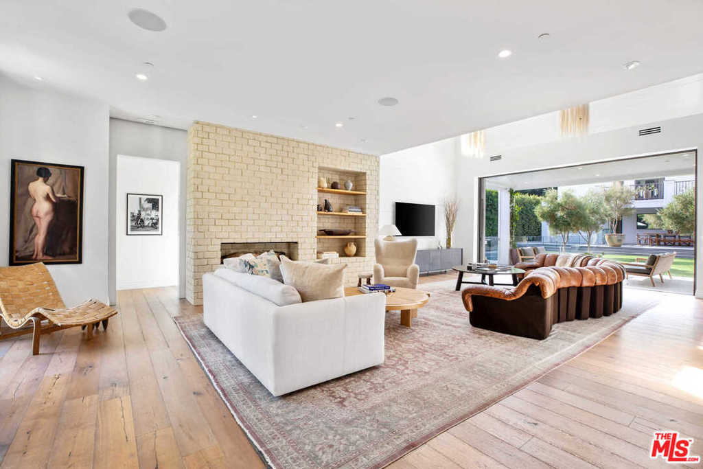 Tucked behind gates and manicured hedges, this stylish and sophisticated home provides the perfect combination of indoor and outdoor living. The main level features an open living area with soaring ceilings and sliding Fleetwood doors, a stunning chef's eat-in kitchen, and a formal dining room. The luxurious master bedroom offers a private terrace, dual walk-in closets, fireplace, and an incredible master bath with an oversized shower and freestanding tub overlooking the lush grounds. Two additional spacious bedrooms with en-suite baths complete the upper level. Other features include a guest house containing a gym and sauna, a screening room, and 3-car garage parking. Conveniently located on a street-to-street lot, so entry can be accessed through Bobolink Place, perfect for those seeking utmost privacy. Truly a unique and rare offering for those who can appreciate something different and tasteful.