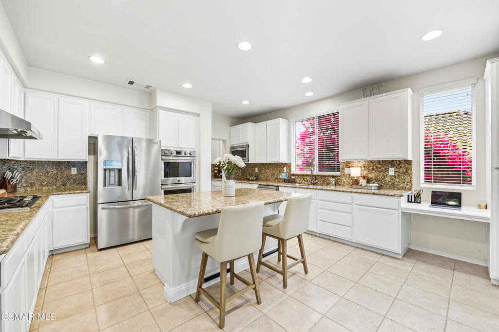 Inside the gated Toscana @ Serenata community, this home delivers what buyers are really looking for: a First-floor Primary suite AND a First-floor secondary ensuite--ideal for multigenerational living, guests, or anyone who prefers most of life on one level. The layout flows with high ceilings, wood floors, and light-filled spaces including formal living and dining, plus a family room with fireplace that opens to the kitchen. The kitchen itself checks every box with a large island, stainless appliances, butler's pantry, and generous storage. Upstairs, find two additional bedrooms with a dual entry bath plus a large versatile study/office space--perfect for kids, grandkids, or working from home. Outside, the backyard offers views, lawn, and paver patio space for entertaining. Additional highlights: 3-car tandem garage, dual-zone HVAC, cul-de-sac location, and excellent Moorpark schools. A rare combination of functionality, flexibility, and community in one of Moorpark's most desirable neighborhoods.