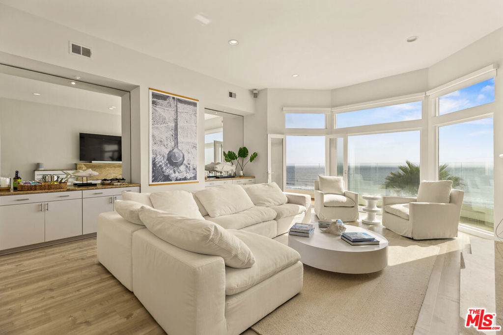 Nestled within the prestigious enclave of Manhattan Beach, this stunning oceanfront penthouse presents unparalleled panoramic views of the Pacific Ocean. Impressively furnished, this single-story condominium showcases a sophisticated sunken living room adorned with a plush Restoration Hardware Cloud sofa and a charming fireplace, providing an ideal retreat for relaxation. The residence features a spacious dining area accommodating 8 guests comfortably, complemented by an open-concept kitchen outfitted with high-end stainless steel appliances. The primary bedroom serves as a tranquil sanctuary, offering serene ocean vistas that provide a soothing backdrop of waves, ensuring a peaceful escape from the daily hustle and bustle. Additionally, there are three generously sized bedrooms, each equipped with motorized blackout shades for optimal privacy and comfort. Adding to the allure, the property includes a versatile den or game room complete with a second fireplace, infusing warmth and luxury. Convenience is paramount, with a practical laundry area conveniently located on the same level. Further elevating this exceptional residence is the provision of three secured parking spaces with direct access to the penthouse. More than just a residence, this penthouse represents a luxurious beachfront sanctuary, harmonizing natural beauty with upscale living in one of Manhattan Beach's most coveted locations.