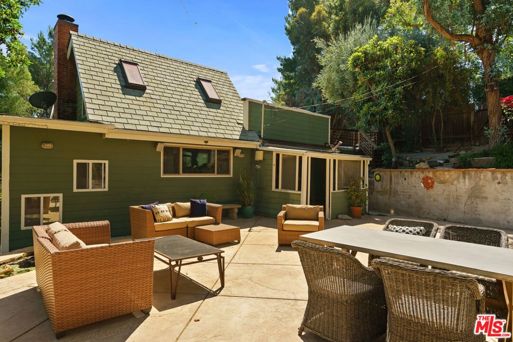 Nestled on a peaceful street off Old Topanga Canyon Road, this light-filled 3-bedroom plus office, 2-bath home is a soulful retreat surrounded by nature and full of rustic charm. High ceilings, expansive windows, and soft natural light throughout create a warm, open atmosphere that embraces the spirit of canyon living. The main living and dining areas offer a comfortable flow, leading into a clean, functional kitchen that's ready for your personal touch. Natural materials and organic tones carry throughout the home, bringing a sense of calm and connection to the outdoors. Each of the four bedrooms feels bright and serene, with the primary suite opening to a private patio perfect for quiet mornings or stargazing nights.