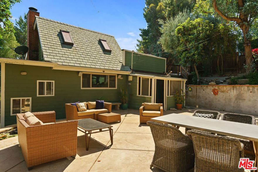 Nestled on a peaceful street off Old Topanga Canyon Road, this light-filled 3-bedroom plus office, 2-bath home is a soulful retreat surrounded by nature and full of rustic charm. High ceilings, expansive windows, and soft natural light throughout create a warm, open atmosphere that embraces the spirit of canyon living. The main living and dining areas offer a comfortable flow, leading into a clean, functional kitchen that's ready for your personal touch. Natural materials and organic tones carry throughout the home, bringing a sense of calm and connection to the outdoors.  Each of the four bedrooms feels bright and serene, with the primary suite opening to a private patio perfect for quiet mornings or stargazing nights.