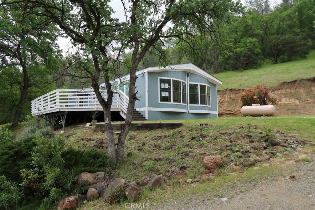 AMAZING PRICE! REDUCED HUD Home in the Rolling Foothills West of Corning! Discover the charm of country living with this ranch-style home nestled on a spacious 1.72-acre lot, offering privacy, peace, and panoramic views. Two bedrooms, two baths With comfortable living space and an inviting floor plan, this home sits on an elevated lot, providing scenic views from every room and endless opportunities to enjoy clear, starry skies. This property provides plenty of space for outdoor activities. Located approximately 12.5 miles west of I-5, between Red Bluff and Corning, this home is part of a friendly rural community with a seasonal creek winding through picturesque oak and pine-covered hills. Enjoy breathtaking views of local mountains in a true wildlife haven. The community also features a private airstrip, perfect for aviation enthusiasts. Outdoor recreation is right at your doorstep, with Black Butte Recreation Area, Lake Shasta, and the Sacramento River all just a short drive away. A must-see retreat for nature lovers and outdoor adventurers alike!