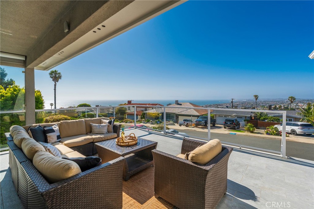 Discover your coastal sanctuary in the highly sought-after Hollywood Riviera of Redondo Beach. This exceptional home offers unparalleled panoramic views, encompassing the Pacific Ocean, sandy beaches, glittering Los Angeles city lights, the majestic San Gabriel Mountains, Downtown Los Angeles, and the iconic Queens Necklace. Enjoy watching boats glide by or the dramatic crash of waves over the Redondo Beach Marina break wall. The main level of this custom home boasts a serene front patio with expansive views, perfect for gathering. The formal living room features a fireplace and a picture window, capturing city lights and sunny day views. It's unique floor plan positions the main living spaces on the upper level to fully capture the spectacular views. Don’t miss the opportunity to own a home in one of the most desirable neighborhoods in the South Bay! Walk or bike to the Riviera Village, El Retiro park, shopping, dining and the beach.
