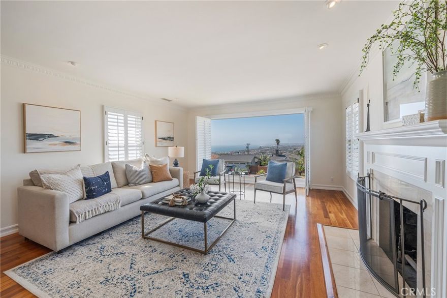 Discover your coastal sanctuary in the highly sought-after Hollywood Riviera of Redondo Beach. This exceptional home offers unparalleled panoramic views, encompassing the Pacific Ocean, sandy beaches, glittering Los Angeles city lights, the majestic San Gabriel Mountains, Downtown Los Angeles, and the iconic Queens Necklace. Enjoy watching boats glide by or the dramatic crash of waves over the Redondo Beach Marina break wall. The main level of this custom home boasts a serene front patio with expansive views, perfect for gathering. The formal living room features a fireplace and a picture window, capturing city lights and sunny day views. It's unique floor plan positions the main living spaces on the upper level to fully capture the spectacular views. Don’t miss the opportunity to own a home in one of the most desirable neighborhoods in the South Bay! Walk or bike to the Riviera Village, El Retiro park, shopping, dining and the beach.