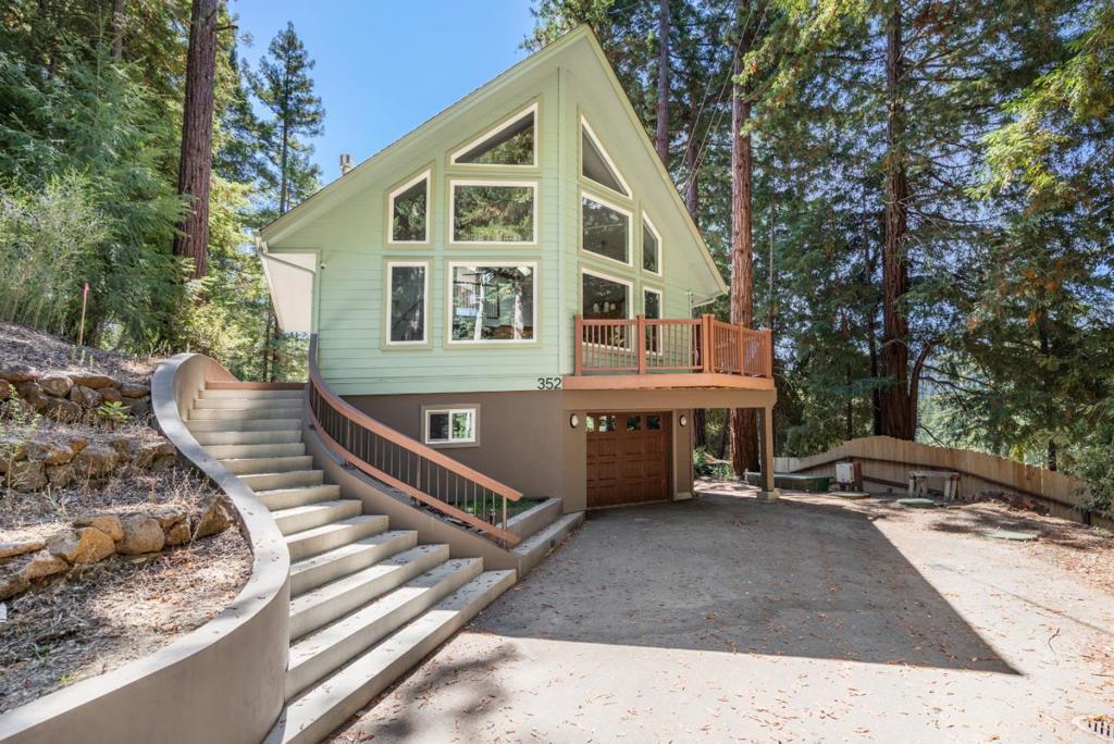 Stunning custom Chalet home surrounded by magnificent mountain views & very close to downtown! The gourmet cook in you will love the oversized Quartzite kitchen island with prep sink, LG Linear inverter refrigerator, Bosch 5 burner gas stove, Whirlpool convection double oven, LG inverter dishwasher, double sinks set in Quartzite and quiet-close drawers. Elegant walnut wood floors, vaulted beam ceilings, full-wall apex view windows, gas fireplace, dramatic curved staircase, 2 bdrms, an office, a full bathroom and many skylights complete the main living area. The upstairs suite has views, views, views, a bathroom with a tile and cascading rock shower, and a jetted spa tub with towel warmers. The downstairs spaces are perfect bonus rooms and include the laundry room and dumbwaiter to all levels! 7 new ductless mini-split systems throughout provide perfect temperature control while the Generac home standby generator guarantees continual power during an outage. There is also a wrap around deck, and an attached garage with an automatic door. The septic is an engineered Advantex AX20 Treatment system manufactured by Orenco and maintained by Bonny Doon Environmental Systems. Property professionally surveyed by Hanagan Land Surveying. All this home needs now is you! Open House 9/6 1-4p.