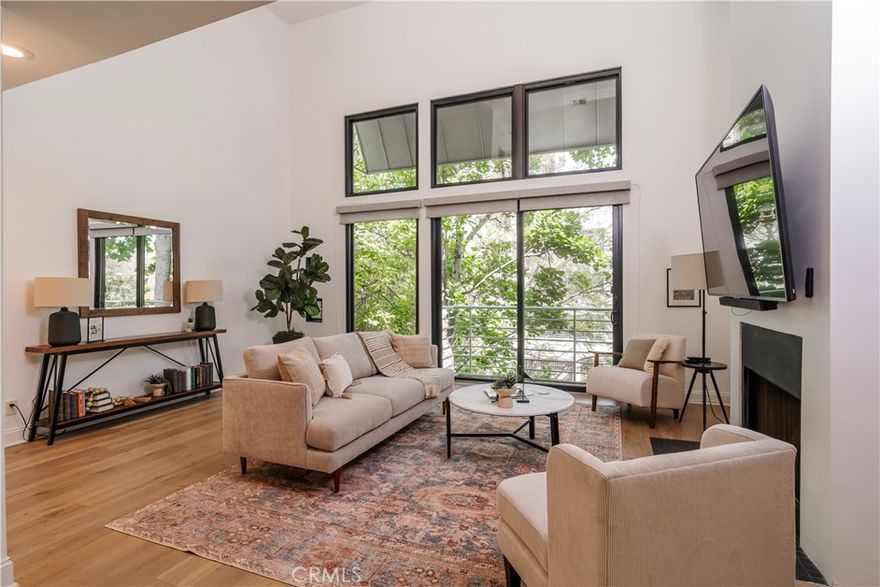 Wow! Finally! A rare opportunity to have it all! Architectural elegance meets modern luxury in this stunning townhome-style condo, designed by renowned architect William Hefner, AIA. Every detail of this residence has been thoughtfully curated, from the rich wood flooring throughout to the soaring ceilings and perfectly aligned balcony doors and windows that flood the space with natural light and offer serene tree-lined views, providing the ultimate in living area. The expansive primary suite is a true retreat, complete with a cozy fireplace and a luxurious en-suite bath featuring a soaking tub—ideal for relaxation or a refreshing cold plunge—along with a separate shower and double vanity. The second bedroom is perfectly suited for a nursery, guest room, or home office. The updated kitchen is both stylish and functional, and comes equipped with a refrigerator. Upstairs, a spacious third-level loft with its own bath opens to a private rooftop patio—perfect for a home office, morning yoga, or hosting friends under the stars. Beyond the beautiful interior and flexible floor plan, this Westwood home’s location is ideally nestled at the end of a cul-de-sac and is within the highly rated Fairburn elementary school boundaries. You’re blocks from Trader Joe’s, Whole Foods, coffee shops and boutique shopping, dining in the Westwood Village and renown Sawtelle blvd. Additional highlights include end unit, no one above and no one below, central A/C, in-unit laundry, two-car parking with an EV charger and a stand alone storage area. A rare opportunity not to be missed—where architectural pedigree, comfort, and convenience converge.