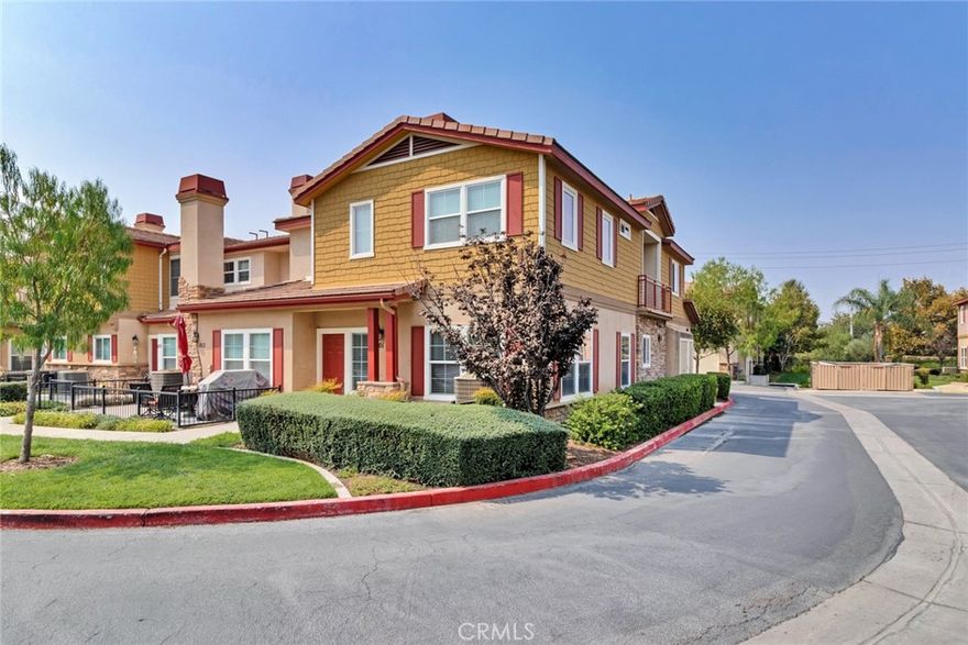 Gated Community of Villa Valencia. The largest floor plan in the community with 3 bedrooms and 2.5 baths. End unit with 1 sharing wall. Walk in closet in the Primary Bedroom and dual sinks in the Primary bath. Private upstairs balcony. Kitchen has stainless steel appliances and granite counters. Great room and Primary Bedroom with a gas fireplace. Laminate wood floors on the main floor and carpet on stairs and second floor. Attached 2 car garage. HOA amenities include pool/spa, clubhouse, picnic area with BBQ, playground, and a half basketball court.