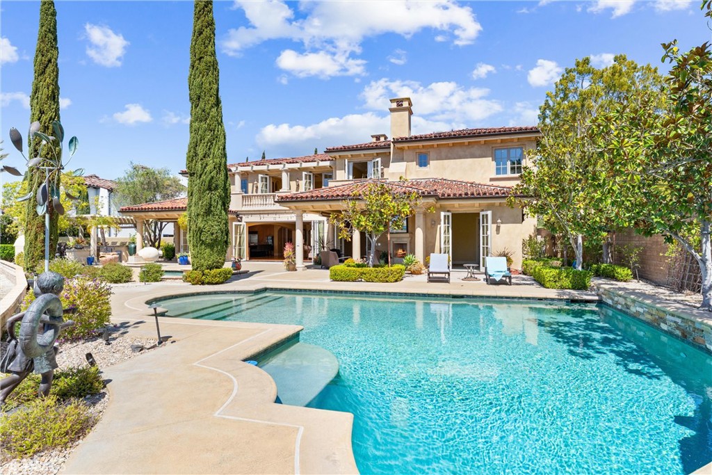 Luxury Italian Villa in a Prime Cul-de-Sac Location with Stunning Views
Located within the prestigious 24-hour guard-gated community of Covenant Hills in Ladera Ranch this spectacular home is nestled at the end of a peaceful cul-de-sac. This exquisite Italian villa-inspired estate offers the perfect blend of luxury, privacy, and functionality. Boasting 5 spacious bedrooms and 5.5 elegantly appointed bathrooms, this custom-designed single-family residence is the epitome of refined living.
Step inside and be captivated by the home’s thoughtful layout and timeless finishes. A gourmet kitchen with a butler’s pantry and wine refrigerator opens to a large family room, ideal for both intimate gatherings and grand entertaining. A dedicated office, bonus room, and wine cellar add to the home’s versatility, providing both relaxation and productivity spaces.
The heart of the home extends outdoors to a resort-style backyard, a true entertainer’s dream. Enjoy the sparkling pool and spa, outdoor TV area, and fully equipped built-in bar and cooking station—complete with its own refrigerator—perfect for year-round enjoyment. A charming courtyard adds a touch of European elegance.
Car enthusiasts and collectors will appreciate the five-car garage, offering ample space for vehicles, storage, or hobbies, and located at the end of the long driveway within the gates of another beautiful courtyard complete with a bubbling fountain.
Covenant Hills offers access to an array of wonderful amenities, including a 24-hour guard gate, clubhouse, water park, skate park, multiple pools, parks, and hiking and biking trails. What a great opportunity to experience all that Covenant Hills has to offer!!
