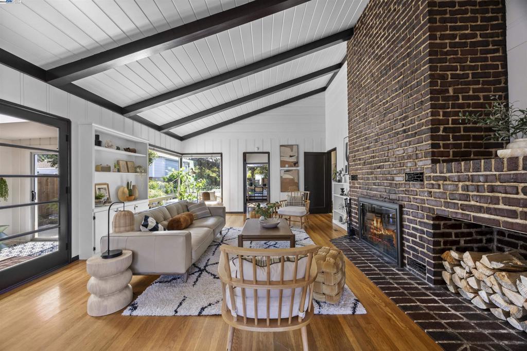 Mid-century modern meets bespoke charm! This single-level Warren Manor home offers seamless indoor-outdoor living, with a spacious backyard featuring a deck and manicured gardens, perfect for entertaining or simply unwinding. Inside, a rich fireplace and a beamed vaulted ceiling capture the warmth of a cabin getaway. Oversized windows showcase an open, airy atmosphere, with plenty of natural light filling the living areas. French doors invite you into a captivating sunroom with outlooks to the gardens and side yard access, offering bonus uses as a den, office or expanded living space. Practical and updated with whole home repiping, new furnace and complete reducting, Owens Corning attic insulation, Titan security door and LifeScape fencing, your new home includes a large two-car attached garage with ample storage. Shop at Trader Joes, retreat at Lake Chabot and be minutes to downtown Castro Valley and Hayward, 2 farmers markets and both BART stations!