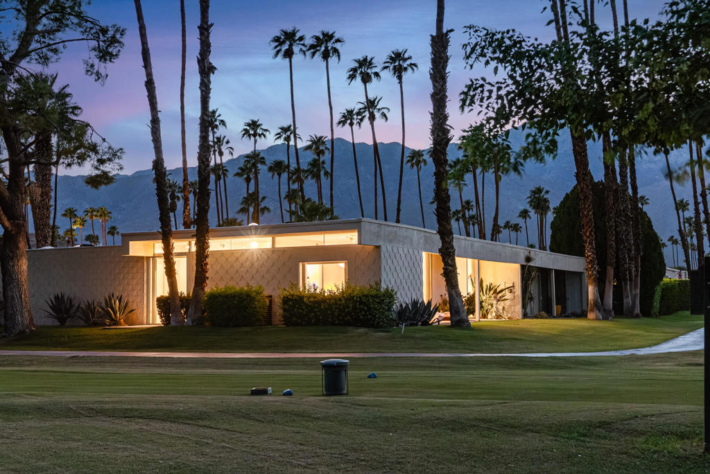 Here is a rare opportunity to own the former home of legendary architect E Stewart Williams, designer of Frank Sinatra's Twin Palms estate, the Palm Springs Art Museum and many more of the city's landmarked treasures. Originally designed by Richard A. Harrison, Williams reimagined this 3 bed/2bath mid century villa, located on the 18th green and the 7th lake at the coveted Seven Lakes Country Club. Enter this getaway, off the quiet cul-de-sac, past shadow block walls to the formal courtyard entry, one of the largest in the complex. Here you'll find a perfect outdoor entertaining space with San Jacinto mountain views. Inside, Travertine floors are cool underfoot as you spread out over the nearly 2000 sq ft open floor plan, Williams reconfigured the spacious living and dining areas, making them ideal for entertaining or just taking in the desert's tranquility. The primary suite had sound dampening put into the walls for ultimate privacy. Enjoy the best of Palm Springs' indoor/outdoor living with walls of glass sliders opening out onto a leisure terrace with fairway views to the North. The large bedrooms offer great closets and outdoor access as well. Other updates include a newer HVAC system and roof . Assigned covered parking is nearby while the tranquil pool is just steps away. Past the 24-hour guarded front gate, 'The Gem of the Desert' offers a unique elevated lifestyle with its Ted Robinson-designed 18-hole executive golf course, 15 pools and spas with poolhouses, tennis courts and the lively William Cody-designed clubhouse with a formal dining room, casual cocktail lounge, and a terrace overlooking the waterfall-fountain. Welcome home!