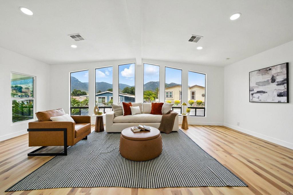 This home is situated in the coveted Champagne Village, it features a Sun deck on the back yard to enjoy coffee or wine & take in the views. YOU OWN THE LAND! This absolutely Stunning Home is completely renovated! 2 bedroom 2 bath home with an open floor plan and high ceilings features a remodeled Kitchen with new shaker style cabinets, Quartz counter-tops, new stainless steel appliances, luxury vinyl plank flooring, updated bathrooms, new interior and exterior paint. Amenities include pickleball, tennis, bocce ball, swimming pool, fitness room, putting green, dog park, and many fun planned activities. Champagne Village is adjacent to the world-famous Welk Resort! You will feel like you are on vacation every day! Gated community with all the amenities one could ask for.