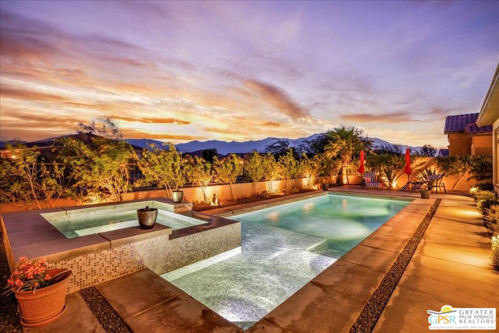 MOUNTAIN VIEWS! Welcome to your private desert retreat in the highly sought-after 55+ community of Del Webb Rancho Mirage. This Phase 4, Plan 8 SERENITY floorplan with Prairie facade features the coveted three-bedroom layout plus a versatile den/flex space and two full bathrooms. Thoughtfully upgraded, the home showcases luxury vinyl plank flooring, custom shutters, and designer light fixtures throughout. The gourmet kitchen impresses with 42" upper cabinets with crown molding and staggered heights, premium cabinetry with dovetail joinery and soft-close drawers, natural granite countertops, a spacious island with seating, and a large walk-in pantry - all overlooking the open-concept great room and dining areas. The light-filled great room boasts soaring 12-foot ceilings, an upgraded in-floor power outlet, and expansive views through to the covered patio and private custom saltwater PebbleTec pool and spa - complete with fire pit, abundant hardscape, and breathtaking mountain vistas. The primary suite is a true sanctuary with stunning mountain views and the rare full-bathroom upgrade, including a large walk-in shower, soaking tub, dual vanities, and a generous walk-in closet. Guests will appreciate their own private wing with two bedrooms and an upgraded full bath, while the den/flex space offers endless possibilities for a home office, yoga room, or media lounge. Additional features include leased SOLAR ($120.05 Mo), an expanded laundry room with utility sink, a beautifully sealed garage floor, soft water plumbing loop, Culligan water softening system, EV pre-wire, and more. As a resident of Del Webb Rancho Mirage, you'll enjoy access to a world-class clubhouse, resort-style pool and spa, state-of-the-art fitness center, tennis and pickleball courts, and a vibrant calendar of social activities designed to suit every interest. This is more than just a home - it's the ultimate in luxury, lifestyle, and community.