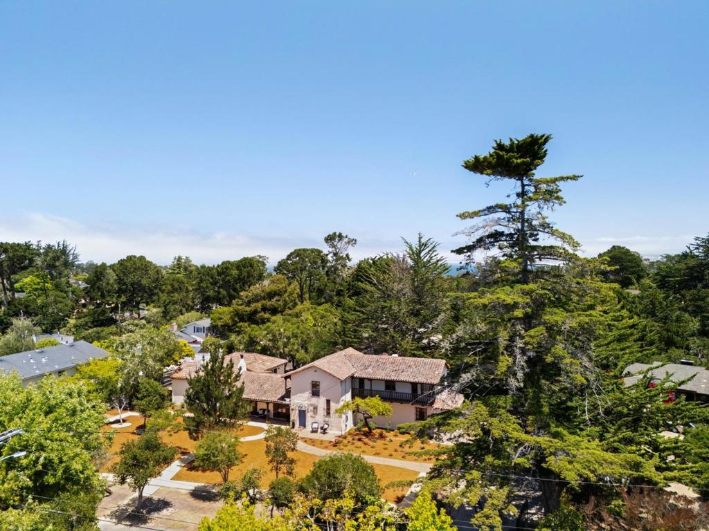 Welcome to Casablanca, a timeless masterpiece nestled in the coveted Peters Gate neighborhood of Monterey. The enchanting Spanish Revival home built in 1930 still has the charm and original details preserved throughout. Set on an expansive 1/2 acre lot, Casablanca offers a serene and private retreat with the energy of downtown Monterey just moments away. Step inside, you'll be captivated by the preserved original hardwood floors and intricate metal ironwork, showcased on the stairwell banister of the curved stairs to the upper floor. The elegant great room features open beam ceiling and fireplace crowned by a stately stone mantle. With five bedrooms and five and a half bathrooms, Casablanca provides ample space for both relaxation and entertaining. There are 2 primary suites, offering flexibility and convenience. One suite is located on the main level, the second suite and additional guest bedrooms reside on the upper floor. Casablanca has been lovingly cared for by its current owner since 1989 and is now ready for its next caretaker to continue its legacy. The home stands as a true classic, ready for restoration to its original splendor. Experience the allure of Monterey living with Casablanca, where history, charm, and location converge in perfect harmony.