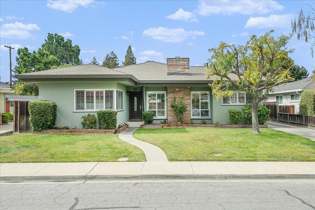 Beautifully refreshed single-story ranch in a quiet Santa Clara neighborhood, just minutes from major tech employers, Santana Row, and Central Park. Formal living room with gleaming hardwood floors and fireplace framed by floor-to-ceiling windows. Updated kitchen with granite counters, designer backsplash, stainless appliances, and custom cabinetry opens to a light-filled dining area. Expansive family room with dramatic rock fireplace and sun tunnels flows to a fully enclosed patio room featuring built-in grill, sink, cabinetry, and rolling European shutters overlooking the sparkling poolideal for year-round entertaining. Primary suite with built-ins, patio access, and spa-inspired bath with curb-less walk-in shower. Two additional bedrooms with hardwood flooring and excellent storage plus a vintage mid-century guest bath. Added versatility with 1BD/1BA ADU, utility/craft area with half bath, and detached 2-car garage with attic storage. Fresh paint, new carpet, lighting, and hardware.