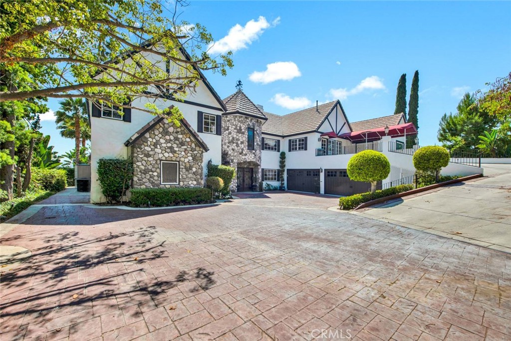 One of the best values per square foot among custom view homes in North Tustin! Welcome to 1532 Kensing Lane, a private, gated retreat nestled in the scenic hills of North Tustin. This one-of-a-kind estate offers breathtaking Catalina Island and city light views and a floor plan designed for elevated everyday living and unforgettable entertaining. Boasting 5 spacious bedrooms, 6 full bathrooms, and 2 half bathrooms, every bedroom includes its own ensuite bath for ultimate comfort and privacy. The thoughtful layout includes dual primary suites—one conveniently located on the main level. Indulge in luxury living with exceptional amenities such as a gym, theater room, wine room, guest house, and an open-concept living space with soaring two-story ceilings and walls of glass that frame the stunning views and flood the home with natural light. The remodeled chef’s kitchen features granite countertops, a stylish tile backsplash, a large center island with bar seating, and top-of-the-line stainless steel appliances, including full-size separate fridge and freezer units, a six-burner gas range, French café-style double ovens, and a wine/beverage fridge. Retreat to the upstairs primary suite, where you'll find a cozy fireplace, balcony access, panoramic views, a walk-in closet with custom built-ins, and a spa-like bath with dual vanities, granite counters, a makeup station, a walk-in shower, and a freestanding clawfoot tub. Step outside to your resort-style backyard, complete with PebbleTec pool and spa with waterfall feature, stone hardscape, putting green, artificial turf, covered patio with fireplace, BBQ island, gazebo, fire pit, Trex decking, and your very own sport/pickleball court. Additional highlights include a 4-car garage with epoxy flooring and built-in storage, a private extended driveway, sauna and steam room, and access to award-winning Tustin schools: Red Hill Elementary, Hewes Middle, and Foothill High. Ideally located near the 241/261 Toll Roads, 5/55/22 freeways, Tustin Ranch Golf Course, and The Tustin/Irvine Marketplace, this extraordinary residence offers luxurious living in one of Orange County’s most coveted neighborhoods. Don’t miss your chance to own this stunning custom estate at 1532 Kensing Lane!