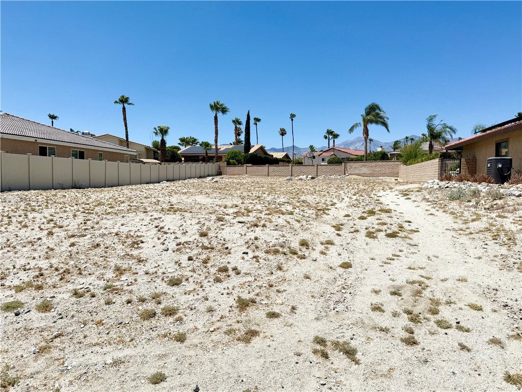 Don't miss this incredible opportunity to own a spacious lot (over 10,000 square feet per tax assessor) in the desirable Mission Lakes Country Club community. With ownership, two people on title receive unlimited golf (cart/trail fee applies) on the stunning Ted Robinson-designed 18-hole championship course—a rare and valuable benefit. Enjoy access to top-tier golf facilities including a driving range, hitting cage, and dedicated chipping and putting areas. The community also offers resort-style amenities such as a Riviera-style pool and spas, tennis and pickleball courts, and a state-of-the-art gym/fitness center. Dine on-site at the San Jacinto Restaurant or the Sand Wedge Café, and take advantage of discounted rates at the Inn at Mission Lakes for you or your guests. Lot is surrounded by three fenced homes—two with block walls and one with vinyl fencing. This lot is ideal for building your dream home in an established neighborhood. Experience luxury desert living in the heart of the Coachella Valley!