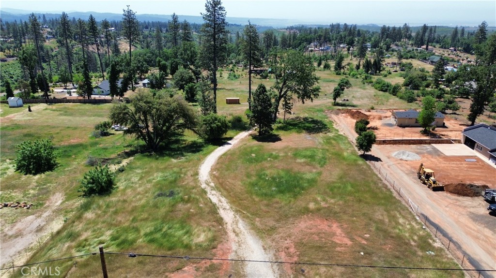 Unique opportunity to own this large, beautiful 3.95 acre parcel in Paradise! Bring your imagination and develop this amazing piece of land into something extraordinary. Build your dream home, creating a secluded oasis right in the middle of town. Or, divide into smaller parcels and create income for your retirement years. The possibilities are endless. A completed survey and an active PID water account are an added bonus!. Drive by, enter off Pearson Road, take the gravel driveway toward the back of the property and enjoy the peace & quiet this spacious, open, hidden gem has to offer.