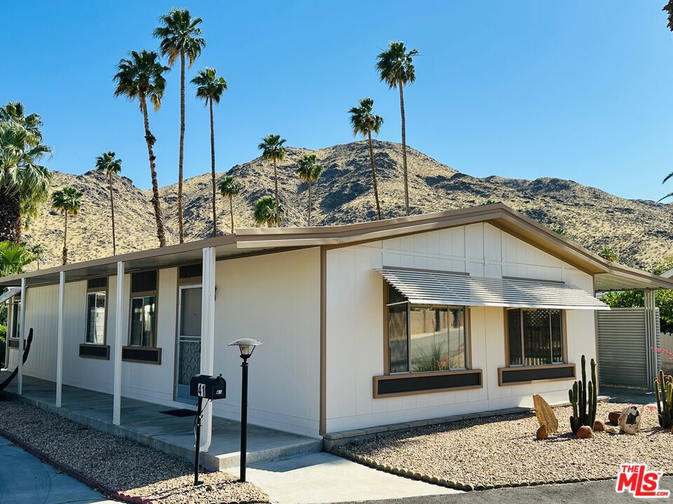 Welcome to 41 Santa Ana - an immaculate, one-owner manufactured home, in mostly original condition, on a rent controlled lot in Palm Springs' fun & funky Safari Park! Located on a less-traveled street in the community, this adorable bungalow-style mobile home has been lovingly cared for over the years and is presented for sale by its ORIGINAL OWNER. With 1,248 square feet of living space, this home features two bedrooms & two bathrooms (including an primary suite), a large living room with vaulted ceilings, a generous kitchen w/ pantry and built-in breakfast bar, a formal dinging room w/ built-in buffet, indoor laundry w/ a desk and room for an upright freezer, garden shed, covered carport, a landscaped front yard, freshly painted exterior... The list goes on and on! Don't miss this one! Safari Park is a 55+ community. Low monthly rent-controlled lot rent of just $492.21 includes water, sewer and trash. Schedule your tour today!