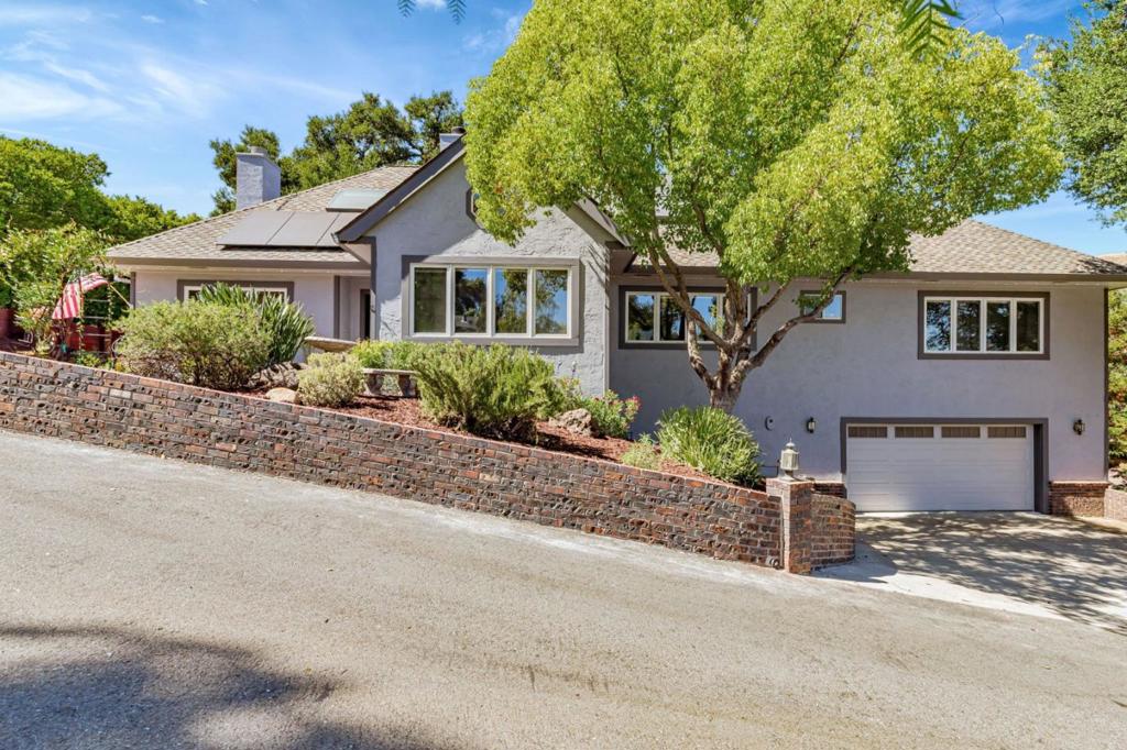 Welcome to your private retreat on idyllic Live Oak Lane, where timeless California living meets modern comfort. Tucked beneath a canopy of heritage oaks on a 16,657 sq.ft. lot, this home feels like a peaceful getaway, yet its just minutes from town. Thoughtfully updated, it offers five bedrooms including a ground-floor primary suite perfect for multigenerational living or working from home. Picture family dinners under cathedral ceilings, cozy evenings by one of four fireplaces, and weekend brunches on the deck overlooking nature. The chefs kitchen features granite slab counters, rich wood cabinetry, and stainless appliances. Hardwood floors and new LED lighting flow throughout. Recent upgrades include owned solar with battery backup, EV readiness, drought-tolerant landscaping, a new deck with built-in seating, and a saltwater hot tub, your own private spa under the stars. With central AC, a wine cellar, and extra-wide garage, this home has it all. Set in the friendly Jackson Oaks community with pool and clubhouse access. Come see where your next chapter begins.
