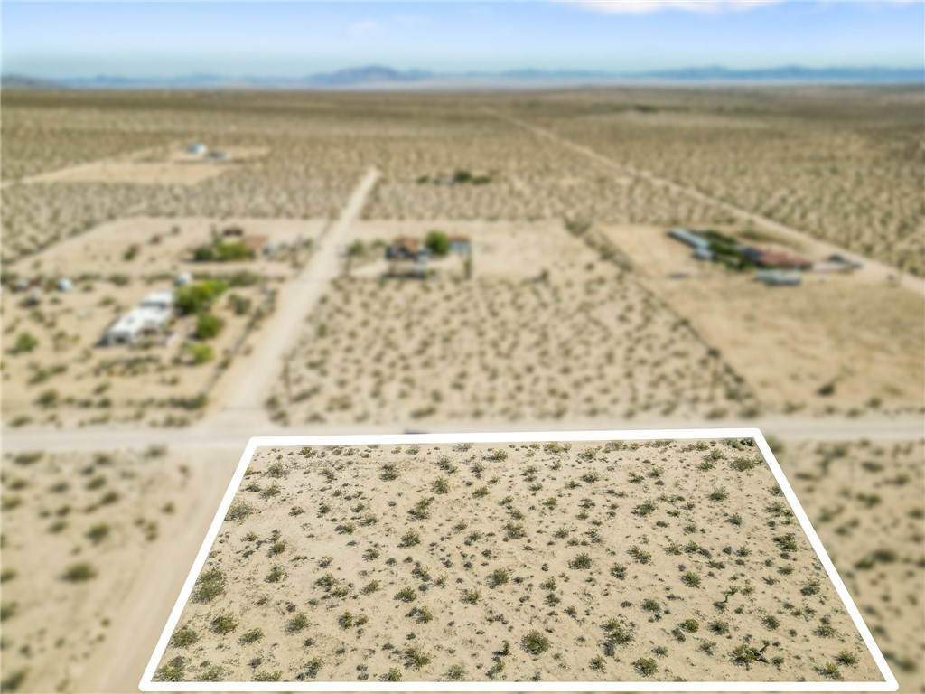 Discover the potential of 62711 Moonlight Mesa Street—a prime 2-acre parcel (87,120 sq. ft.) nestled in one of the most dynamic and sought-after regions of Joshua Tree. Located just two blocks from paved Border Avenue, this easily accessible property offers a rare blend of privacy, natural beauty, and proximity to key destinations. With water and electricity at the street and a legal address already assigned, this lot is ready for your vision—whether it's a custom desert retreat, short-term rental, or long-term investment. Surrounded by stunning views of Mt. San Gorgonio, Mt. Nebo, the Bullion Mountains, and the Little San Bernardino range, the landscape is a daily inspiration. The area is experiencing rapid growth, with high-end homes and designer builds emerging throughout North Joshua Tree. Just 10 minutes to the National Park entrance and JT Village, and only 17 minutes to the Monument where over 3 million visitors come each year, this parcel sits in the heart of a thriving vacation rental market. It’s also a short drive to Landers, Flamingo Heights, Yucca Mesa, and iconic attractions like Pioneertown and Pappy & Harriet’s. Whether you're planning an Airbnb compound, a soulful weekend getaway, or an architecturally inspired dream home, this is a rare chance to invest in the future of Joshua Tree. Set up camp, park your RV, or start drawing up plans—the canvas is wide open and the stars are waiting. Buyer to verify all zoning, usage, and utility availability with San Bernardino County and utility providers.