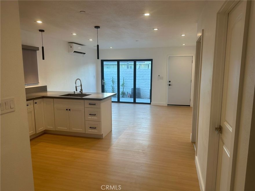 LARGE 2 BEDROOM + 1 BATH NEW CONSTRUCTION ADU FIRST FLOOR WITH WOOD FLOORING, STAINLESS STEEL APPLIANCES, QUARTZ COUNTERTOPS IN GOURMET KITCHEN, SPACIOUS BEDROOMS EACH WITH OWN AIR CONDITIONING UNIT, CEILING FANS IN BEDROOMS. DOWNSTAIRS WITH PRIVATE PATIO, DUAL PANED WINDOWS.  REFRIGERATOR, LARGE LAUNDRY ROOM/STORAGE WITH WASHER & DRYER HOOKUPS.  PRIVATE 1 CAR PARKING.  SOLAR INCLUDED TO HELP REDUCE UTILITY BILLS.  ASSIGNED PARKING.  CLOSE TO SHOPPING & DINING.  THIS IS A MUST SEE!