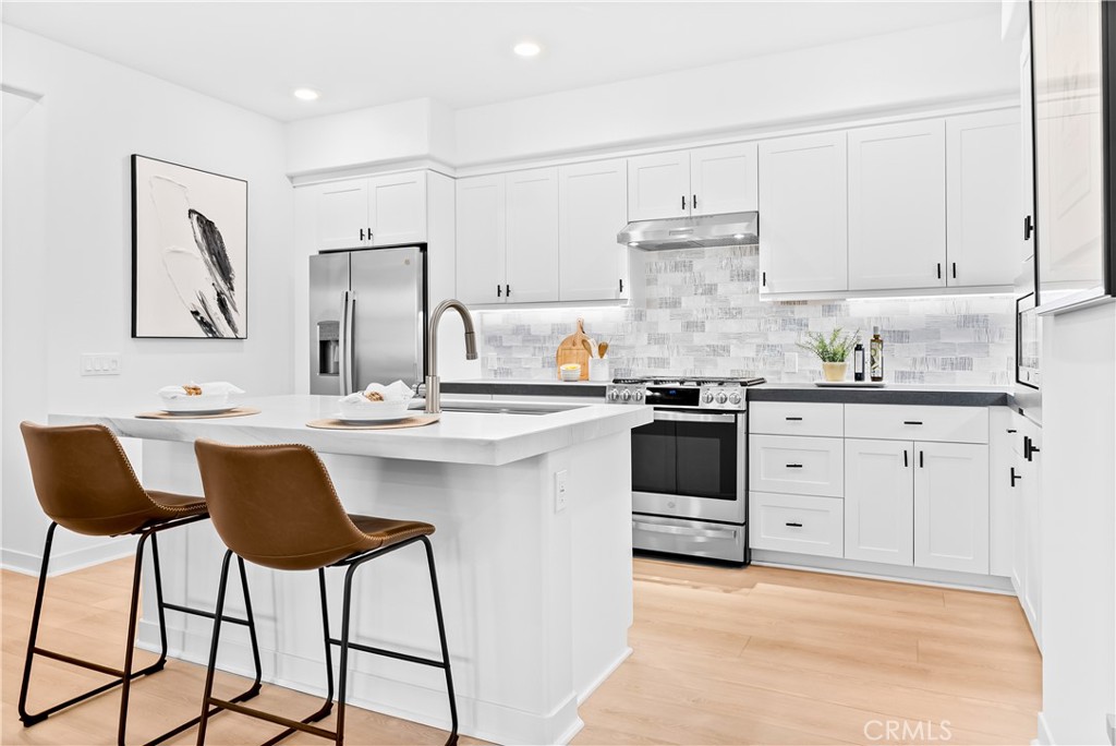 Set in the coveted Portico enclave of Rancho Mission Viejo, this upgraded single-level flat blends modern design with everyday ease in one of Rienda’s most walkable locations. This home is just moments from Boulder Pond, the park/playground, the Ranch Cove, and near the planned Rienda K–8 School opening in 2027. Inside, an open great room unites the kitchen, dining, and living spaces in a smooth, social flow that opens to a private deck for sunrise coffee or golden-hour gatherings. A versatile den adapts to your life, home office, reading nook, or creative studio while a split-bedroom layout gives the serene primary suite welcome privacy and a comfortable second bedroom for guests or loved ones. Thoughtful upgrades elevate every detail: luxury vinyl plank flooring throughout; fully paid solar; quartzite satin counters at the kitchen island and primary bath; porcelain counters in the back kitchen and secondary bath; vessel sinks with new Vigo faucets; a designer backsplash; Zebra shades; and an attached garage with ample storage. Move-in ready and beautifully positioned, this home delivers the charm, convenience, and lifestyle that make Rancho Mission Viejo so sought-after. If you’ve been waiting for the right combination of design, walkability, and community in Rancho Mission Viejo, this is the one. Immerse yourself in the exceptional amenities of Rancho Mission Viejo, including the vibrant Ranch Camp, the state-of-the-art Ranch Cove community pool and gym, and countless recreational opportunities that define the unmatched lifestyle of this community. Exclusive to Rancho Mission Viejo residents are all amenities in the Villages of Sendero, Esencia, Rienda and future Villages. There are community amenities for all from breath-taking resort-style pools and spas, Esencia school K-8, community farms, fitness centers, guest house, putting green, bocce ball courts, tennis and pickle ball courts, playgrounds, coffee shop, fire pits, an arcade and so much more!