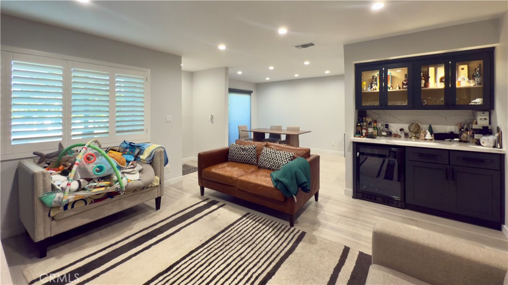 Welcome to this beautifully upgraded townhouse in the heart of Sylmar, located directly across the street from El Cariso Community Park and Golf Course offering you daily access to open green space, recreation, and leisure just steps from your front door. This family friendly neighborhood is known for its strong sense of community and proximity to some of the area’s top amenities, including Los Angeles Mission College, scenic hiking trails, and convenient shopping centers like Sylmar Towne Center and Hubbard Plaza. Nearby schools and quick freeway access make this an ideal location for both families and professionals alike. This 3 bedroom, 2.5 bathroom townhouse has been meticulously cared for and tastefully upgraded throughout truly a one-of-a-kind residence. The owner has spared no expenses, with custom-built cabinetry, a fully remodeled kitchen, and an elegant mini bar complete with a built-in mini fridge and highlight shelves to create the perfect ambience for entertaining. Additional standout features include: Beautiful laminate flooring throughout, freshly painted smooth walls for a clean modern look, recessed lighting for a modern, bright ambiance, custom plantation shutters on windows, fully renovated bathrooms with upscale finishes, central air conditioning and heating for year-round comfort, attached private garage and well-maintained community with pride of ownership. Whether you’re enjoying the nearby parks, hiking the scenic local trails, or relaxing in the comfort of your stunningly updated home, this property offers the perfect blend of style, comfort, and convenience.