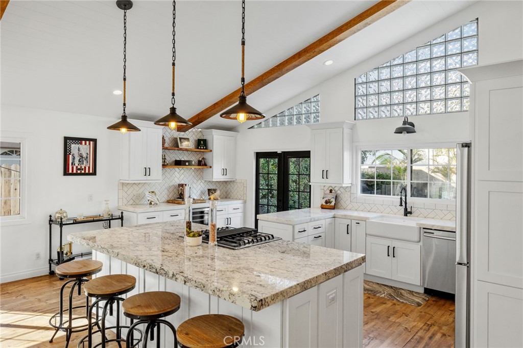 Stunning 2-Story Torrance Home with Double Master Suites, Modern Farmhouse Kitchen, Pool, and Prime Location! Welcome to this beautifully upgraded 2-story home nestled in one of Torrance’s most desirable and family-friendly neighborhoods. This thoughtfully designed residence features 3 spacious bedrooms and 3 full bathrooms, including two luxurious master suites, offering comfort, style, and flexibility for today’s modern living. As you step through the front door, you're greeted by a bright, open-concept floor plan with a large vaulted living room highlighted by white shiplap ceilings and exposed wood beams. The space flows seamlessly into a stunning, fully remodeled modern farmhouse kitchen, complete with a massive island ideal for gatherings, high-end stainless steel appliances, and elegant granite and marble countertops. Enjoy year-round comfort with central A/C and heating, and peace of mind with the home being pre-wired and ready for an ADT security system. You'll also appreciate the new farmhouse-style double-paned windows, which flood the home with natural light while improving energy efficiency and sound insulation. Both the fenced-in front yard and backyard with a sparkling, fenced-in pool offer safe, private spaces for kids and entertaining. The backyard is beautifully landscaped with tall privacy hedges and swaying palm trees, creating your own personal retreat. For added convenience and security, the home includes a brand new remote-controlled garage door with safe and secure off-street parking. Located in a quiet, safe neighborhood, this home is walking distance to top-rated preschools, elementary, middle, and high schools, as well as local libraries and numerous parks. You're just 3 miles from the beach, with quick and easy freeway access making commuting a breeze. This rare Torrance gem combines modern style, smart upgrades, and unbeatable location. Don’t miss your opportunity—schedule your private tour today!