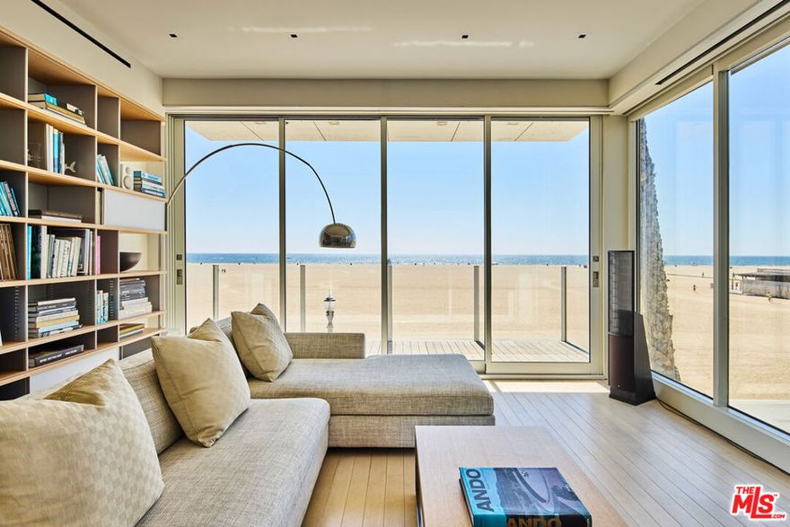 Introducing The Palisades Beach House  a striking architectural gem crafted by Seagull Design and perched directly on the sand in Santa Monica. Completed in 2018, this three-story modern residence redefines coastal luxury with panoramic ocean views from every level, a rare indoor stainless-steel pool with chemical-free, UV-purified water, and a 1,000 sq. ft. subterranean garage complete with a car turntable. The penthouse primary suite features a private covered deck and an expansive closet, while the living room is designed for elevated entertaining, outfitted with an oversized projector, Martin Logan speakers, and a custom Philippe Starck sofa. A sleek Boffi kitchen is equipped with Miele and Gaggenau appliances, and the entire home is wired with invisible built-in surround sound. With a private elevator, a spa, rich teak floors, and direct pedestrian access to Santa Monica's vibrant restaurants and shops via a footbridge, The Palisades Beach House offers an unmatched blend of sophistication, privacy, and beachfront lifestyle.
