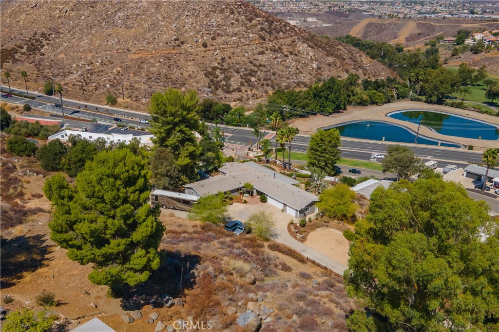 BE Kings or Queens of this hill! Almost 5 acre parcel in Canyon Lake gated estates with all the amenities of the community and you OWN the land. If you are seeking endless views, room to roam, privacy and serenity then welcome to this home that checks all the boxes. A long private driveway leads to your huge parking area with room to park 2 RV's and detached 3 car garages. A lovely breezeway as you approach the home for those afternoon breaks in the day to view and enjoy your surroundings. As you enter the home you are greeted with a very large family room centered by stone stacked pellet burning fireplace. Plank flooring and lots of windows make this home bright and airy. There is a formal dining room off the very well equipped large gourmet kitchen. Pantry, Double ovens, gas range, vast cabinetry and farm sink are a few of the upgrades you will notice first. Off to the 3 very good sized bedrooms, 2 full baths, and private laundry room with door to outside. Primary suite offers 2 closets, ensuite bathroom. Enjoy the back covered patio with full outdoor kitchen to entertain and share with your friends and family. And don't forget the shed. The roof has been redone as well as completely remodeled interior. Shows like a designer dream home, your clients will not be disappointed. This home is truly unique and special.