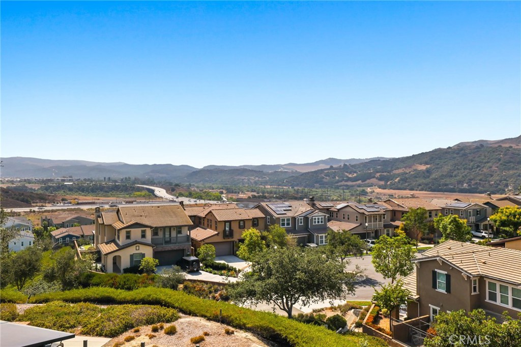 Largest Plan • Expansive Lot • Best View in Vireo 55+
Crowning on one of the largest yards in Vireo—with the sought-after Model 3X floor plan and panoramic vistas including a peek-a-boo ocean view on clear days—65 Listo Street offers unmatched 55+ living. Inside, soaring ceilings and abundant sunlight fill the great room, highlighting wood flooring that seamlessly connects living and dining spaces. The adjacent kitchen features rich cabinetry, stainless-steel appliances, generous storage, and a walk-in pantry—perfect for both casual mornings and effortless entertaining. Both bedrooms are conveniently located on main level, each with plush carpeting and ensuite baths. The primary suite includes a double vanity and walk-in shower. Upstairs, a spacious loft opens to a private balcony—ideal for morning coffee or evening sunsets over coastal and backcountry scenery. Outdoors, the covered patio and low-maintenance yard maximize enjoyment of the unobstructed views. This turnkey home is enhanced with paid-off solar, tankless water heater, PEX plumbing, water filtration system, and an alarm system, plus a two-car garage. Residents of Vireo enjoy exclusive Gavilán® 55+ amenities—The Hacienda, The Outlook, The BBQ Barn, The Getaway’s saltwater pool & spa, fitness/yoga studios, bocce, fire pits, and social lounges—along with full access to Esencia’s all-ages facilities. Schedule your private tour today.