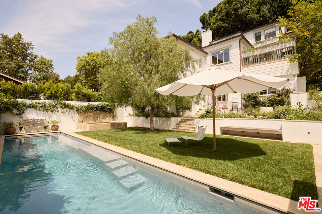 Bold and bespoke Santa Monica Canyon stunner available for long-term lease. Recently remodeled to near perfection a level of finish rarely found in a furnished lease offering. Set behind privacy gates, this secure compound features a motor court, pool and spa, outdoor kitchen, and sweeping canyon and ocean views. The main level is perched above the street, showcasing a dramatic great room with hand-carved beam ceilings and a wood-burning fireplace. The kitchen includes a dining area, while an alfresco dining deck overlooking the estate and ocean sits just across from a cozy den. Upstairs houses the primary suite along with two additional bedrooms. The lower level offers a fully appointed guest suite with a stylish living and entertainment room that opens to the exterior. Privacy and security are paramount in this incredibly refined residence.