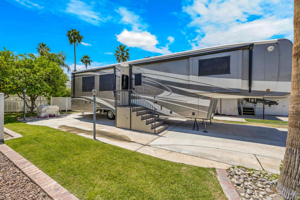 Experience the perfect blend of outdoor living and luxurious comfort with this exceptional lot/RV package. Situated on a gorgeous expanded interior lot, this property boasts an abundance of lush grass on both the patio side and rear, creating an inviting and versatile outdoor space. Mature fruit trees provide natural shade, perfect for al fresco dining and entertaining in the beautiful desert climate.Conveniently located near the vibrant El Saguaro Clubhouse, the golf starter shack, and a hub of resort activities, this property offers easy access to all the amenities. 1 The included RV is a stunning 2021 DRV Mobile Suites MS41RKSB4, featuring a highly desirable rear kitchen layout, offering both functionality and style for your Palm Springs adventures.Outdoor Resorts Palm Springs is a Five Star RV Resort Community combing luxury with affordability. It's a guard gated resort that sits on 137 beautifully landscaped acres, with 27 holes of executive golf, 10 tennis courts, 13 pickle ball courts, 8 swimming pools, a fully equipped fitness center, sports bar, beauty salon/barber shop, full service restaurant, convenience store, 2 club houses, activities special events and so much more.