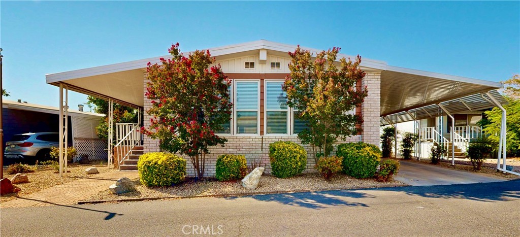 Experience the ultimate retirement lifestyle in this beautifully designed 2-bedroom, 2-bath home, located in one of the desirable 55+ gated communities. This property showcases pride of ownership and features a large living room with built-ins and a fireplace, as well as a spacious dining area. It has generously sized bedrooms. The primary bedroom is also spacious, offering a walk-in closet with ceiling fans in each bedroom. The laundry room provides ample space and additional storage. Outside, you will find a 2-car carport along with one shed on the property. The community has a park and a dog park, offering a picturesque setting. This vibrant, amenity-rich community is designed for active and social living. Residents have access to a clubhouse and banquet hall, perfect for social gatherings, community dinners, and special events. The swimming pool, hot tub, and sauna provide a relaxing retreat, while the fitness center and lighted tennis courts help residents stay active. Golf enthusiasts will love the golf course home sites and putting green, while those who enjoy friendly competition can take advantage of the game room, billiards, bingo, ping pong, card tables, and horseshoes. For those who enjoy a quieter setting, the library and meeting rooms offer peaceful spaces for reading and socializing. This pet-friendly community also features a dedicated dog park, along with craft clubs and social events that bring neighbors together. The BBQ area and regular community dinners provide excellent opportunities for outdoor dining and mingling. Additional conveniences include an RV storage area and laundry facilities, making day-to-day living stress-free. With its blend of comfort, convenience, and an active social scene, this home offers the perfect setting to embrace retirement living at its finest. Don’t miss out on this incredible opportunity.