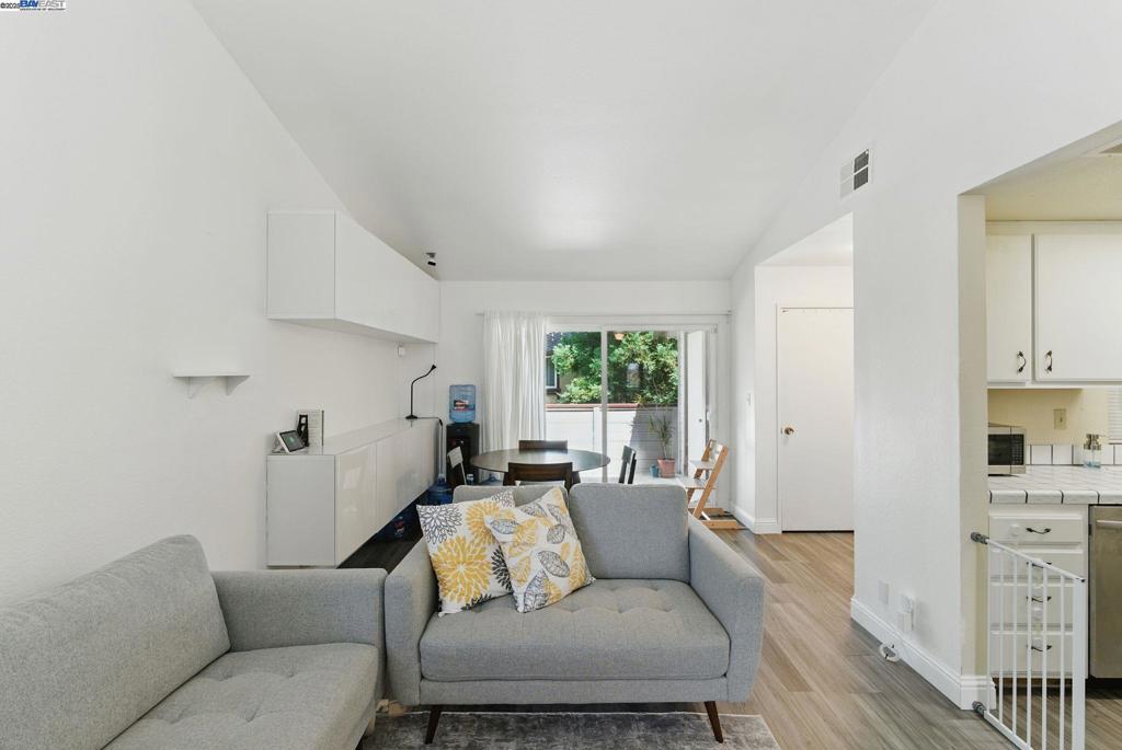 Welcome to this beautifully maintained 2-bedroom, 2-bathroom corner unit offering 840 sqft living space. With double-pane windows on two sides, this home is filled with natural light and provides excellent insulation. This home features upgraded laminate flooring throughout, complemented by built-in cabinets that offer both style and smart storage. The kitchen features a new refrigerator, and the in-unit laundry comes equipped with a new washer/dryer and a new water heater tank all typical of a single-family home setup, bringing both convenience and efficiency. Step out onto the private balcony, perfect for morning coffee or relaxing evenings. This unit also includes a spacious open layout that blends living and dining areas effortlessly. Located next to a community and kids' park, and just across from City Hall, the public library, and police station, this condo offers unbeatable access to essential amenities. Enjoy quick freeway access and proximity to the Dumbarton Bridge, minutes away from the new Newark Costco and popular Fremont restaurants, blending suburban comfort with urban convenience. Don't miss this rare opportunity to own a move-in ready home in a desirable, commuter-friendly location!