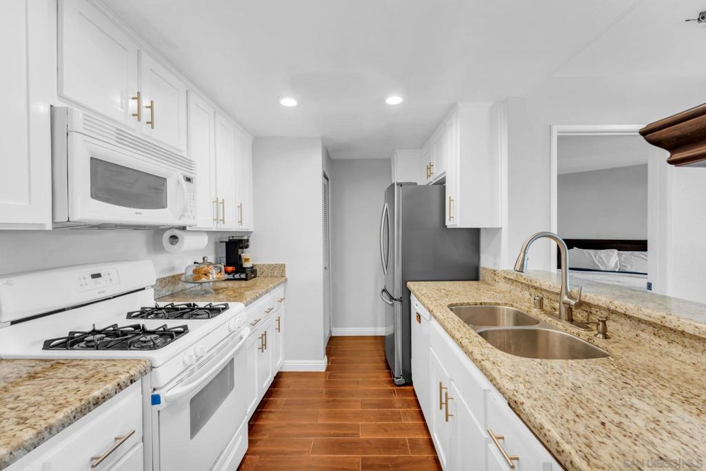 Looking for a turnkey condo but need privacy... this is the one! This beautiful 2-bedroom, 2-bath condo features a spacious floor plan. Placing both bedrooms on opposite sides of the unit, each with its own full-size bathroom, this unit is perfect for added privacy, guests, or roommate living.The kitchen features granite countertops and opens to a warm, inviting living space with updated flooring throughout.. Enjoy in-unit laundry (washer and dryer included), fireplace, carport parking and direct access to your own private backyard patio—ideal for morning coffee, pets, or unwinding with your favorite drink at the end of the day. The amenities in this community do not disappoint... include a sparkling pool, spa, tennis courts, BBQ areas, and a park-like setting. HOA covers water, trash, and exterior maintenance for low-stress living. FHA and VA approved, and conveniently located near shopping, dining, theatres, sweetwater reservoir and freeway access, this condo is move-in ready. Disclaimer, the superheros you spotted in the photos.. they stay with the seller, but the good vibes are yours for the taking! Don't miss this one!