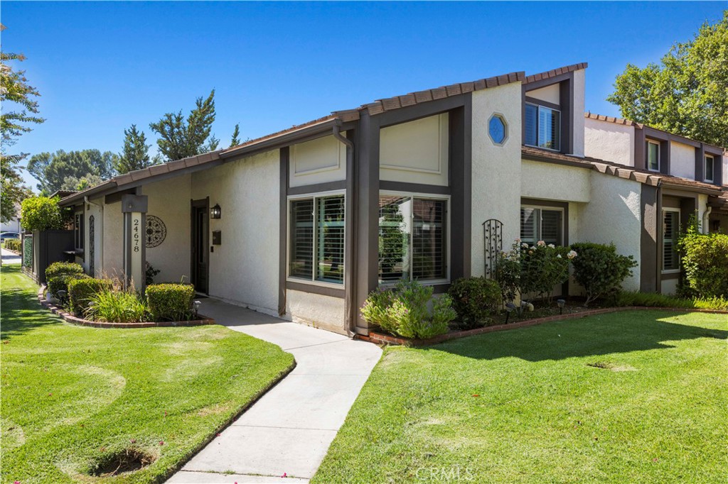 Extremely RARE find in the Fairways! This upgraded and remodeled, 4-bedroom end unit on one of the largest lots in the tract, is a treasure! Privacy from all sides! Upon entry you feel the spaciousness with the vaulted ceiling, recessed lighting and the living area has been expanded by utilizing the lower guest bedroom (Easily reversed by replacing the wall if needed. Beautiful wood flooring and upgraded tile blend seamlessly to create a cool yet welcoming feel. The Chefs Kitchen is built for both entertainment and practical purposes with the deep stainless-steel sink, Corian Counters, practical pull outs / soft close cabinetry and a Gas range. There is a smooth entertainment flow from the dine-in kitchen - out to the upgraded patio/yard complete with a ceiling fan. The Lower-Level Primary suite has dual closets and marble/granite stonework throughout with upgraded vanity. Upstairs you will find 2 additional bedrooms; one with an oversized walk in storage area and another upgraded travertine full bath. The Staircase has even been upgraded and enclosed with additional storage in the hallway. The direct access garage with an epoxy finished floor completes the picture. This PUD (planned unit development) with no neighbors next to you and only one partial shared wall is a true find. The community is walking distance to Vista Valencia Golf Course, The Cal Arts campus and even College of the Canyons. And freeway access is right around the corner at McBean Prkwy. The community includes 3 pool/spa areas, a playground, tennis courts, BB court and security patrol. Meadows Elementary is the assigned elementary school! Don’t miss this opportunity!