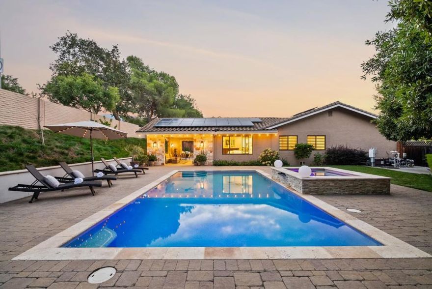 The Consummate California Lifestyle ~ Where everyday feels like a vacation! Experience the best of CA living in this beautifully upgraded Almaden home.  Enjoy an expansive resort-inspired backyard featuring a sparkling pool and spa with waterfall, Forno Piombo Pizza Oven, built-in firepit, and a stunning permitted 452 sq foot covered outdoor living space with TV, fridge, ice maker, sink, and speakers, perfect for entertaining and the best place to take a nap! This backyard is exceptional for adults and kids alike and fabulous for gathering with your favorite people sitting fireside or playing cornhole! Inside, discover lovely features including custom wood cabinetry throughout, white oak hardwood floors,  remodeled modern kitchen with Carrara marble backsplash, and a spacious primary suite overlooking the verdant yard with gorgeous pool views. The primary bath boasts premium fixtures, 92in dual vanity, porcelain countertop and walk in closet. Modern upgrades include solar, tile roof, updated HVAC, EV charging, and whole-home water filtration. Surrounded by lush landscaping, fruit trees, and ambient lighting, this exceptional home truly feels like your own private resort. Located walking distance to Guadalupe Elementary and in the fabulous and very special Oak Canyon Neighborhood!