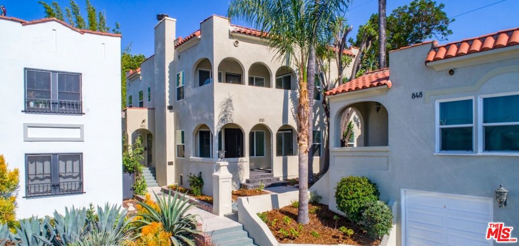 Your opportunity is here to enjoy the updated throughout downstairs home with easily accessible inviting common backyard in this Melrose Hill historic district Spanish Triplex. Privately set back from the cul de sac includes spacious floor plan with views of the Hollywood Hills from the living room with gas fireplace, formal dining, and private front porch. Large kitchen with quartz countertops and subway tile backsplash, separate laundry room with side by side washer/dryer. Generous size bedrooms share hallway bathroom with walk-in shower. Central air and one car garage with additional second car parking tandem behind makes this your new Hollywood home. Available 10/15/25 for move-in.