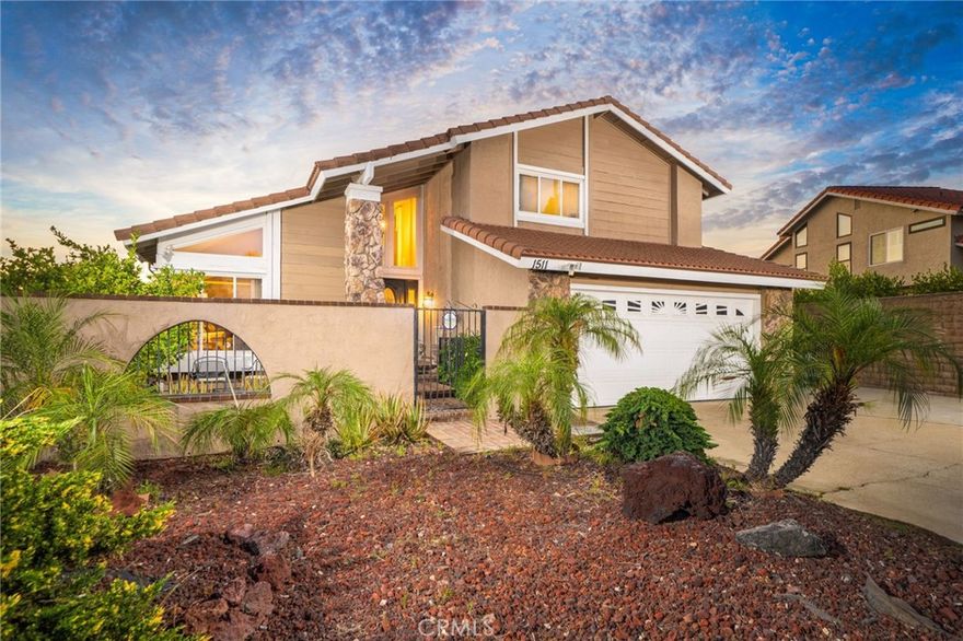 This stunning tri-level home is nestled in the hills of Diamond Bar, offering breathtaking panoramic views and perfectly positioned to capture gorgeous sunsets from the serene backyard or the private upstairs balcony. This residence includes a highly desirable downstairs bedroom and full bath, ideal for guests or multi-generational living. When entering the home you step into the formal living room where rich wood flooring and custom crown molding add timeless elegance and character. Step down into the formal dining area which leads you to the kitchen and family room, perfect for entertaining. The kitchen is a true delight, featuring oak cabinetry, granite countertops, custom backsplash, stainless steel appliances including a 5-burner stove, brand new sink, faucet, and garbage disposal, and an eat-in dining area with a Hunter ceiling fan. Upstairs, the primary suite is a peaceful retreat with double-door entry, two large closets (including a walk-in), an additional hidden storage closet behind the paneled wall, and a private balcony with unobstructed views. The ensuite bathroom boasts dual sinks, and a jetted bathtub with a window to take in the gorgeous view. Two additional guest bedrooms and a full bathroom with a tub/shower combo complete the top level. Accessibility features are present in every bathroom, promoting safety and ease of movement. Thoughtfully upgraded, the home includes dual-paned windows, a 4-ton AC unit, stair climber to provide added ease for navigating between levels, new security system with cell phone access, indoor laundry, and the home has been repiped with PEX plumbing. The downstairs bathroom features a walk-in shower with new brass fixtures. Outside you will enjoy a tranquil and private front courtyard with a mature lemon tree, a covered backyard patio, and a lower terrace that could be perfect for a future jacuzzi. The backyard is adorned with an array of fruit trees including orange, avocado, peach, nectarine, pomegranate, and loquat. Landscaped beautifully with a large fountain, it is a retreat you never have to leave home to enjoy. A 2-car garage and extended driveway offer plenty of parking, as well as additional parking that is readily available along the street with long stretches of curb for ample space for your guests. Located near top-rated schools, shopping, dining, and easy access to the 60 and 57 freeways, this exceptional home offers comfort, convenience, and stunning natural beauty.