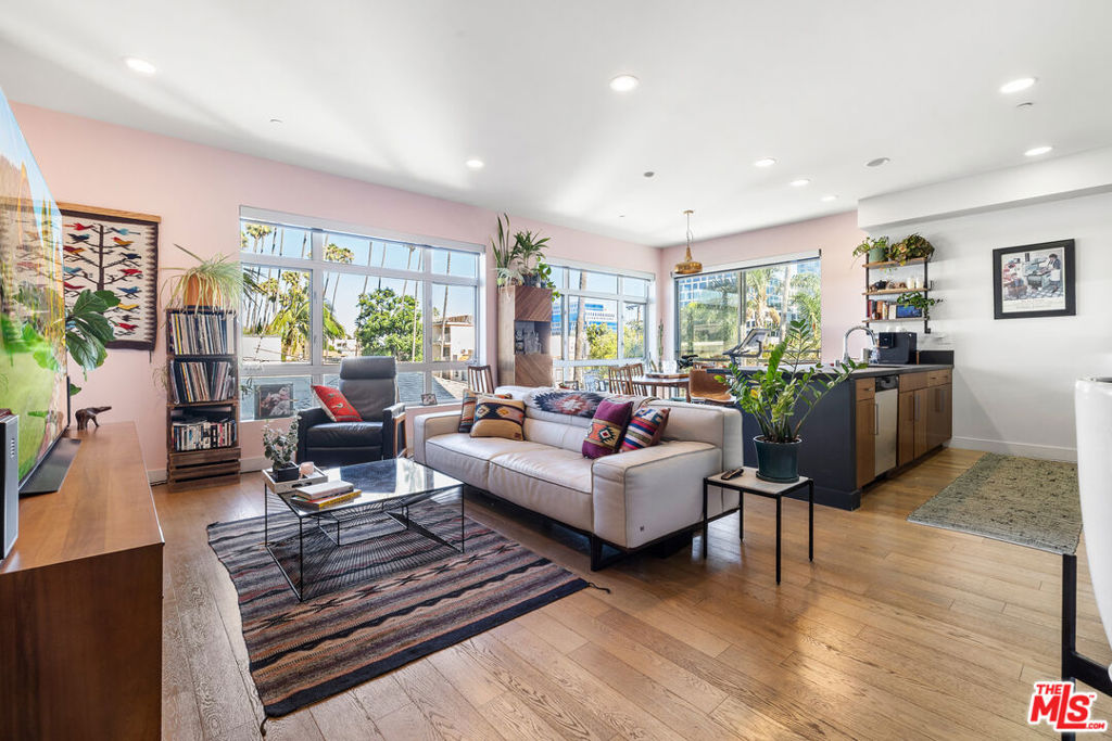 Welcome to 6001 Carlton Way #311, a stylish 2-bedroom, 2-bathroom condo offering 1,230 sq. ft. of modern living in the heart of Los Angeles. This bright and open home features 9-foot ceilings, American oak hardwood floors, floor-to-ceiling windows with solar electric shades, and a private balcony. The kitchen boasts stone countertops and stainless steel appliances, while the luxurious primary suite includes a spacious walk-in closet and spa-like bathroom with Carrara marble finishes, rain shower, soaking tub, dual sinks, and a fog-less upgraded vanity mirror. Additional upgrades include new window panes, Nest thermostat with Google Smart Home integration, and in-unit laundry hookups (washer/dryer negotiable). The building has been extensively updated with a remodeled lobby and gym, new intercom system, and full drainage and waterproofing improvements throughout. Residents enjoy 2 side-by-side parking spaces, 20+ guest spots, EV chargers in the gated garage, and HOA amenities that cover water, trash, building maintenance, common areas, the gym, and a sky deck. Offering modern upgrades and thoughtful building improvements, this home combines comfort, convenience, and city living at its best.